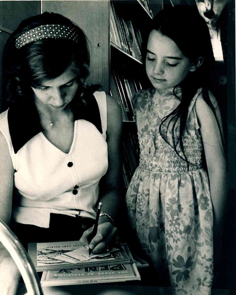 1969 Elaine recommending books to a girl b&w 8X10 photo.jpg