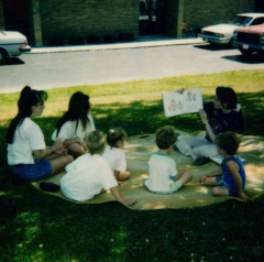 1993 SRP Brunch Buddies, Miss Carol reading outside