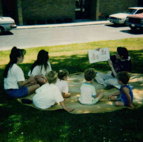 1993 SRP Brunch Buddies, Miss Carol reading outside.jpg
