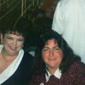 1995 Dec. 15 Staff and Board Christmas Party, Evelyn Cedzidlo of Welcome Wagon and Roxanne Long, Trustee